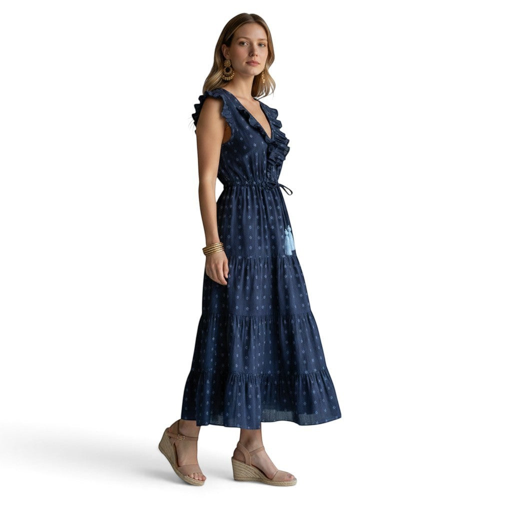 Mer St. Barth navy blue Swiss dot maxi dress with ruffle neckline, flutter sleeves, and tiered skirt on a model.