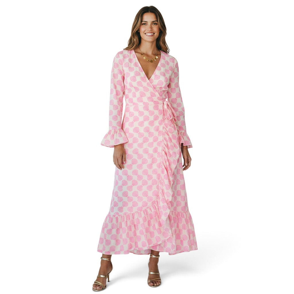 Mer St. Barth Genevieve wrap dress in shell beach pink with ruffle details and long sleeves worn by a smiling model