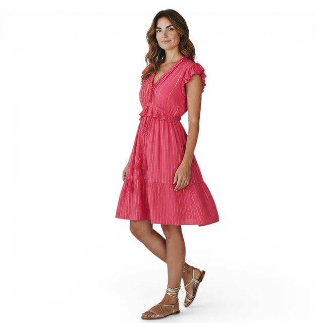 Mer St. Barth Coralie fuchsia lurex mini dress with ruffled neckline and sleeves, cinched waist, and tassel details.