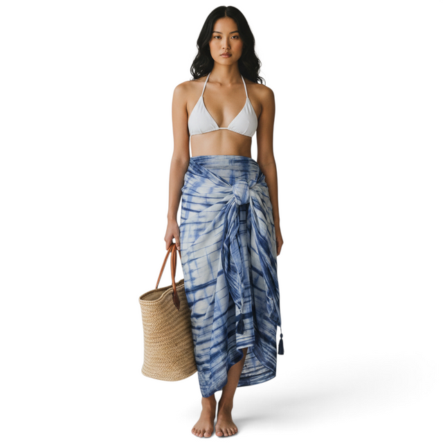 Mer St. Barth cotton pareo in marine shibori tie-dye print worn as a beach cover-up with a straw tote bag