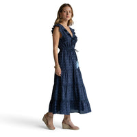 Mer St. Barth navy blue Swiss dot maxi dress with ruffle neckline, flutter sleeves, and tiered skirt on a model.