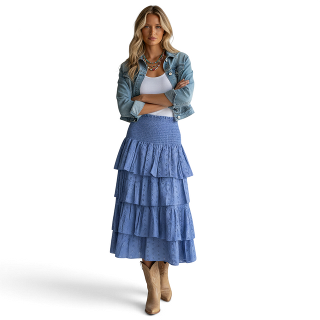 Mer St. Barth Karmin ocean blue eyelet ruffle skirt worn by a model with a denim jacket and tan cowboy boots