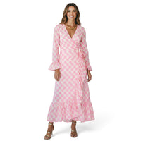 Mer St. Barth Genevieve wrap dress in shell beach pink with ruffle details and long sleeves worn by a smiling model