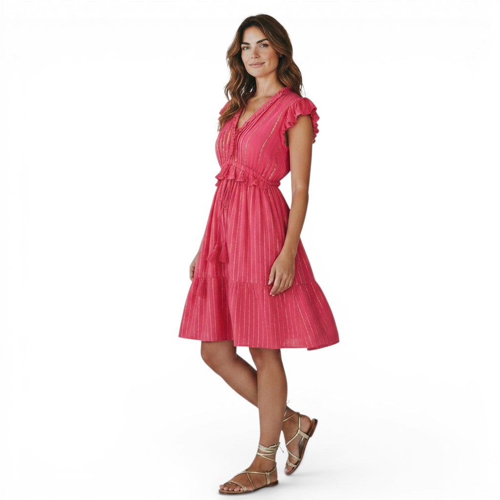 Mer St. Barth Coralie fuchsia lurex mini dress with ruffled neckline and sleeves, cinched waist, and tassel details.